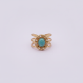 Bague océan turquoise dorée fond lilas