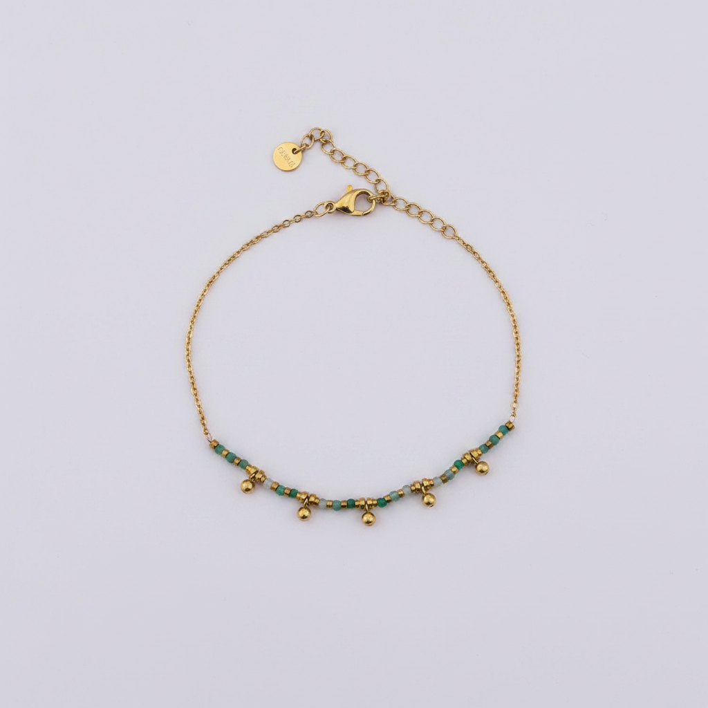 Bracelet perles vertes doré fond lilas